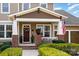 Inviting front porch with brick accents, white pillars, and decorative plants framing the entry at 3439 Richards Xing, Fort Mill, SC 29708