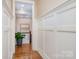 Well-lit hallway with wainscoting detail and a glimpse of the staircase at 3439 Richards Xing, Fort Mill, SC 29708