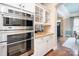 Gourmet kitchen featuring stainless steel appliances, double ovens and white custom cabinetry at 3439 Richards Xing, Fort Mill, SC 29708