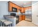 Kitchen area featuring brown cabinets, stainless steel appliances, and bar seating at 3439 Richards Xing, Fort Mill, SC 29708