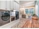 Functional laundry room with side-by-side washer and dryer, butcher block counters, and brick floors at 3439 Richards Xing, Fort Mill, SC 29708