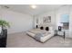 Bright bedroom with a comfortable bed, side tables, and abundant natural light from multiple windows at 40189 Crooked Stick Dr # 1205, Lancaster, SC 29720