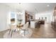 Bright open floor plan with dining area and kitchen featuring modern lighting and stainless appliances at 40189 Crooked Stick Dr # 1205, Lancaster, SC 29720