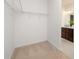 Walk-in closet in neutral tones, equipped with shelving and carpeted flooring at 40189 Crooked Stick Dr # 1205, Lancaster, SC 29720