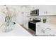 Modern kitchen features stainless steel appliances, white cabinets, and a stylish backsplash for a contemporary feel at 40189 Crooked Stick Dr # 1235, Lancaster, SC 29720