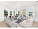 Bright living room featuring hardwood floors, large windows, and modern decor, creating an inviting atmosphere at 40189 Crooked Stick Dr # 1235, Lancaster, SC 29720