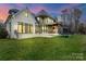 Expansive backyard featuring a manicured lawn, trampoline, and a white brick home exterior at 4336 Tottenham Rd, Charlotte, NC 28226