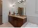 Bathroom featuring a double vanity with granite countertops and dark wood cabinets, and decorative lighting at 4336 Tottenham Rd, Charlotte, NC 28226
