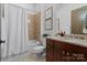 Well-lit bathroom features a shower-tub combo with elegant tiling and a granite vanity at 4336 Tottenham Rd, Charlotte, NC 28226