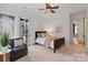 Bright bedroom boasts large windows, plush carpet, and a decorative ceiling fan at 4336 Tottenham Rd, Charlotte, NC 28226