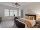 Bright bedroom boasts large windows, plush carpet, and a decorative ceiling fan at 4336 Tottenham Rd, Charlotte, NC 28226