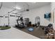 Spacious home gym including treadmill and weight training equipment with rubber flooring and garage door access at 4336 Tottenham Rd, Charlotte, NC 28226