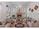 Elegant living room featuring a stone fireplace, large windows, and comfortable seating at 4336 Tottenham Rd, Charlotte, NC 28226