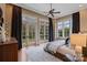 Spacious main bedroom with hardwood floors, a ceiling fan, and access to outdoor scenery from the french doors at 4336 Tottenham Rd, Charlotte, NC 28226