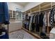 Spacious walk-in closet with built-in shelving, drawers, and a window for natural light at 4336 Tottenham Rd, Charlotte, NC 28226