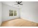 Bright, minimalist bedroom with hardwood floors and large window providing natural light at 503 Norris Ave, Charlotte, NC 28206