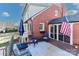 Brick home featuring a patio with seating and an American flag at 632 N Oakland Ave # Pt1, Statesville, NC 28677