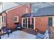 Brick home featuring a patio with seating and an American flag at 632 N Oakland Ave # Pt1, Statesville, NC 28677