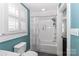 Bright bathroom featuring a tub with white tile surround, a neutral shower curtain, and a window with shutters at 632 N Oakland Ave # Pt1, Statesville, NC 28677