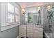 Bright bathroom boasts a marble vanity, window with shutters, and luxurious glass shower at 632 N Oakland Ave # Pt1, Statesville, NC 28677