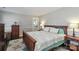 Cozy bedroom with a wooden bed frame, soft patterned bedding, and a calming, neutral color palette at 632 N Oakland Ave # Pt1, Statesville, NC 28677
