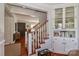 Inviting entryway with staircase, hardwood floors, and a charming built-in cabinet with glass doors at 632 N Oakland Ave # Pt1, Statesville, NC 28677