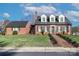 Classic brick home featuring a well-maintained lawn, a brick walkway, and complementary shutter accents at 632 N Oakland Ave # Pt1, Statesville, NC 28677