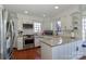 Well-lit kitchen with stainless steel appliances, granite countertops, white cabinetry, and hardwood floors at 632 N Oakland Ave # Pt1, Statesville, NC 28677