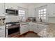 Modern kitchen with stainless steel appliances, granite countertops, white cabinetry, and a cozy round rug at 632 N Oakland Ave # Pt1, Statesville, NC 28677