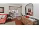 Inviting living room featuring hardwood floors, an elegant mirror, and a glimpse of the staircase at 632 N Oakland Ave # Pt1, Statesville, NC 28677