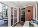 Cozy enclosed porch with brick detail, decorative window, and black front door at 632 N Oakland Ave # Pt1, Statesville, NC 28677