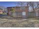 The backyard of this brick home features mature trees, a wood fence, and a brick patio at 7526 Dorn Cir, Charlotte, NC 28212