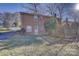 A brick apartment building with a well-maintained lawn and partial fence offers a cozy outdoor space at 7526 Dorn Cir, Charlotte, NC 28212