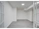 The basement is spacious with modern gray wood-look flooring, white walls, trim, and closet space at 7526 Dorn Cir, Charlotte, NC 28212