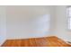 Bedroom with hardwood floors, a window, and bright neutral walls provides a calm space at 7526 Dorn Cir, Charlotte, NC 28212