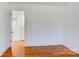 Spacious bedroom with hardwood floors and bright white walls for a fresh, modern look at 7526 Dorn Cir, Charlotte, NC 28212