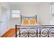 Bedroom with a metal bed frame, hardwood floors, and natural light from a window and a closet at 7526 Dorn Cir, Charlotte, NC 28212