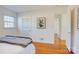 Bedroom featuring hardwood floors, window for natural light, closet, and neutral decor at 7526 Dorn Cir, Charlotte, NC 28212