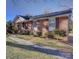 Charming brick home with manicured lawn and walkway leading to the front door at 7526 Dorn Cir, Charlotte, NC 28212