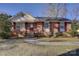 Charming brick home with manicured lawn and walkway leading to the front door at 7526 Dorn Cir, Charlotte, NC 28212