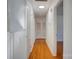 Bright hallway with hardwood floors and white walls leads to various rooms with classic finishes at 7526 Dorn Cir, Charlotte, NC 28212