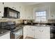 Cozy kitchen with black appliances, tiled backsplash, and a bright, airy atmosphere at 7526 Dorn Cir, Charlotte, NC 28212