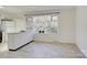 Bright kitchen with breakfast bar, white cabinets, and large bay window at 7526 Dorn Cir, Charlotte, NC 28212
