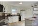 Bright kitchen with white cabinets, black appliances, and a window over the sink at 7526 Dorn Cir, Charlotte, NC 28212