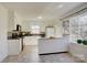 Bright kitchen with breakfast bar, white cabinets, black appliances, and a large window at 7526 Dorn Cir, Charlotte, NC 28212