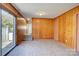 This wood-paneled living room has stairs, a slider door, and wood-look flooring at 7526 Dorn Cir, Charlotte, NC 28212