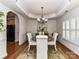 Stylish dining area features elegant furniture, chandelier, and a beautiful rug at 1012 Preakness Blvd, Indian Trail, NC 28079