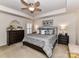 This main bedroom has neutral walls, carpet, trey ceiling, and a decorative ceiling fan at 1012 Preakness Blvd, Indian Trail, NC 28079