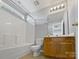 This bathroom features a tub and shower combo, a single vanity and updated fixtures at 10462 Trolley Run Dr, Cornelius, NC 28031