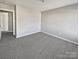 This bedroom features neutral walls and plush carpet at 10462 Trolley Run Dr, Cornelius, NC 28031